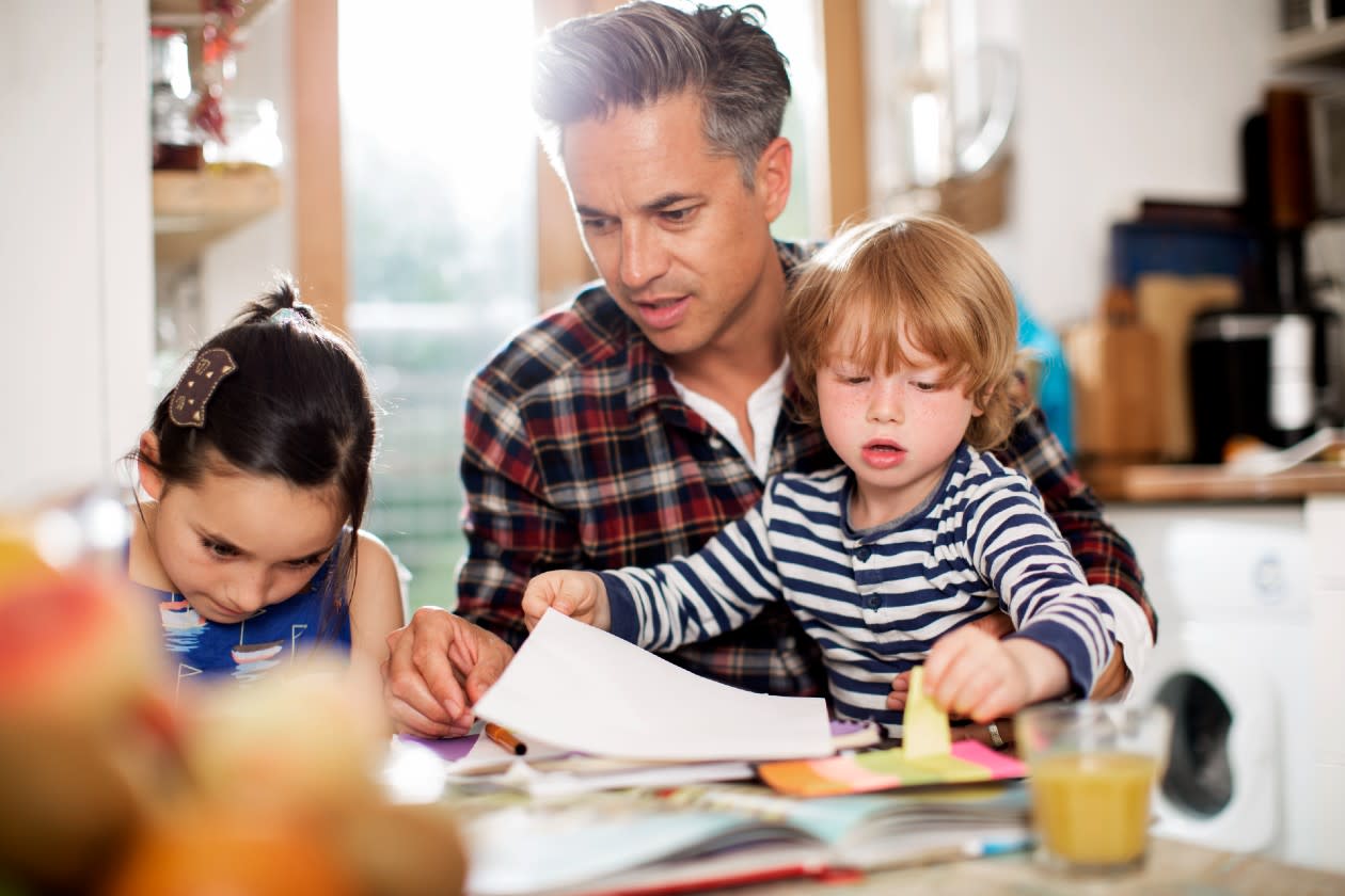 Father and two children drawing together in a kitchen.jpg