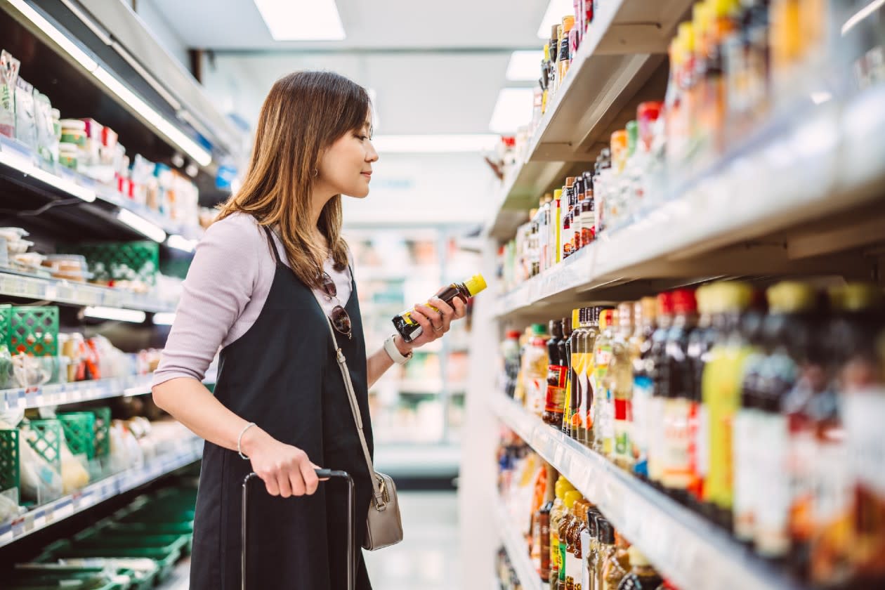 Female shopper looking at supermarket condiments.jpg