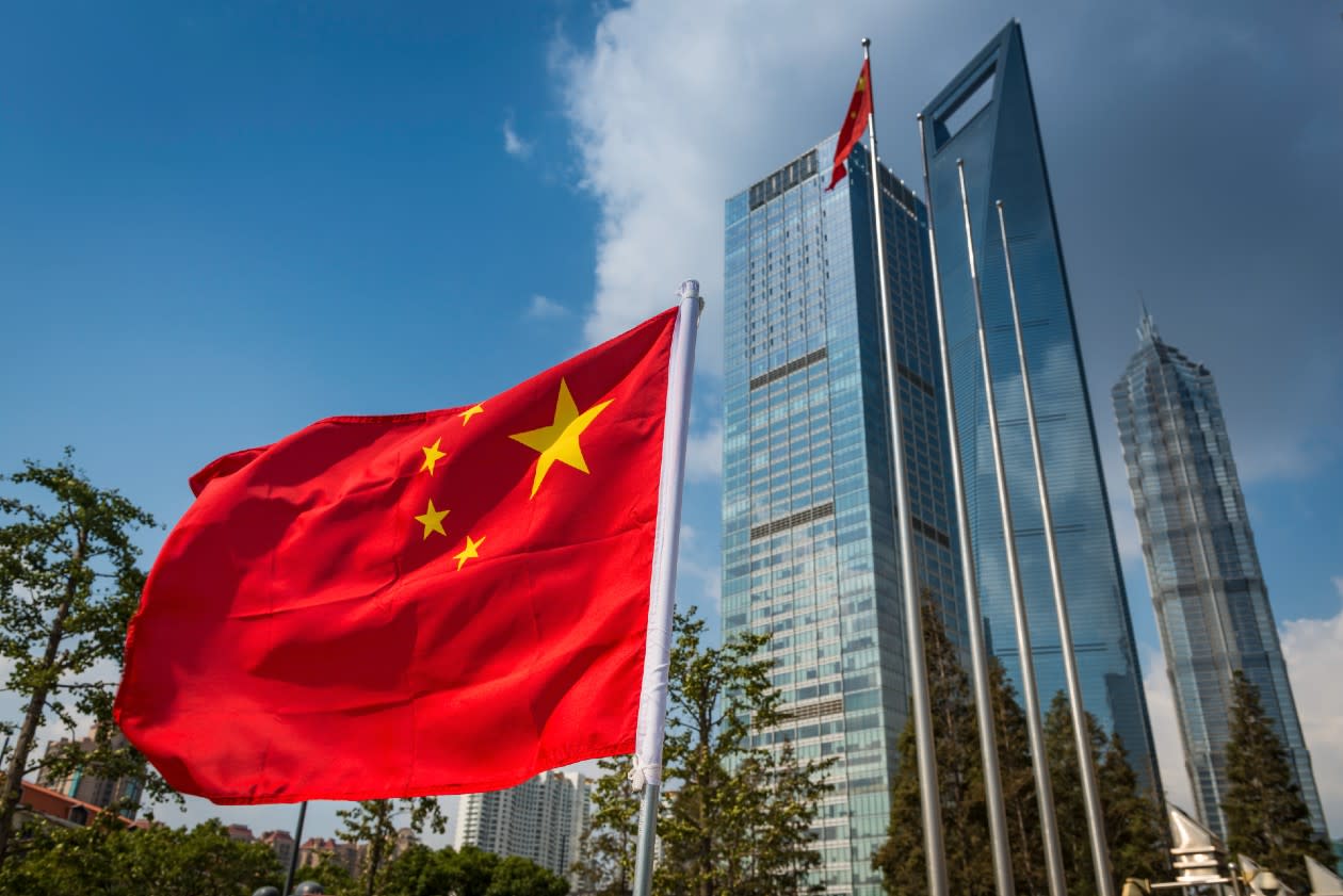 A chinese flag with city skyscrapers in the background.jpg
