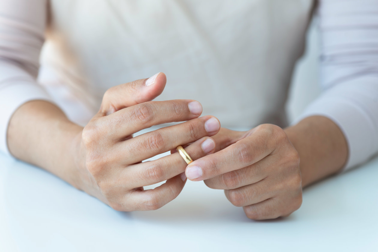 Hands taking off wedding ring.jpg