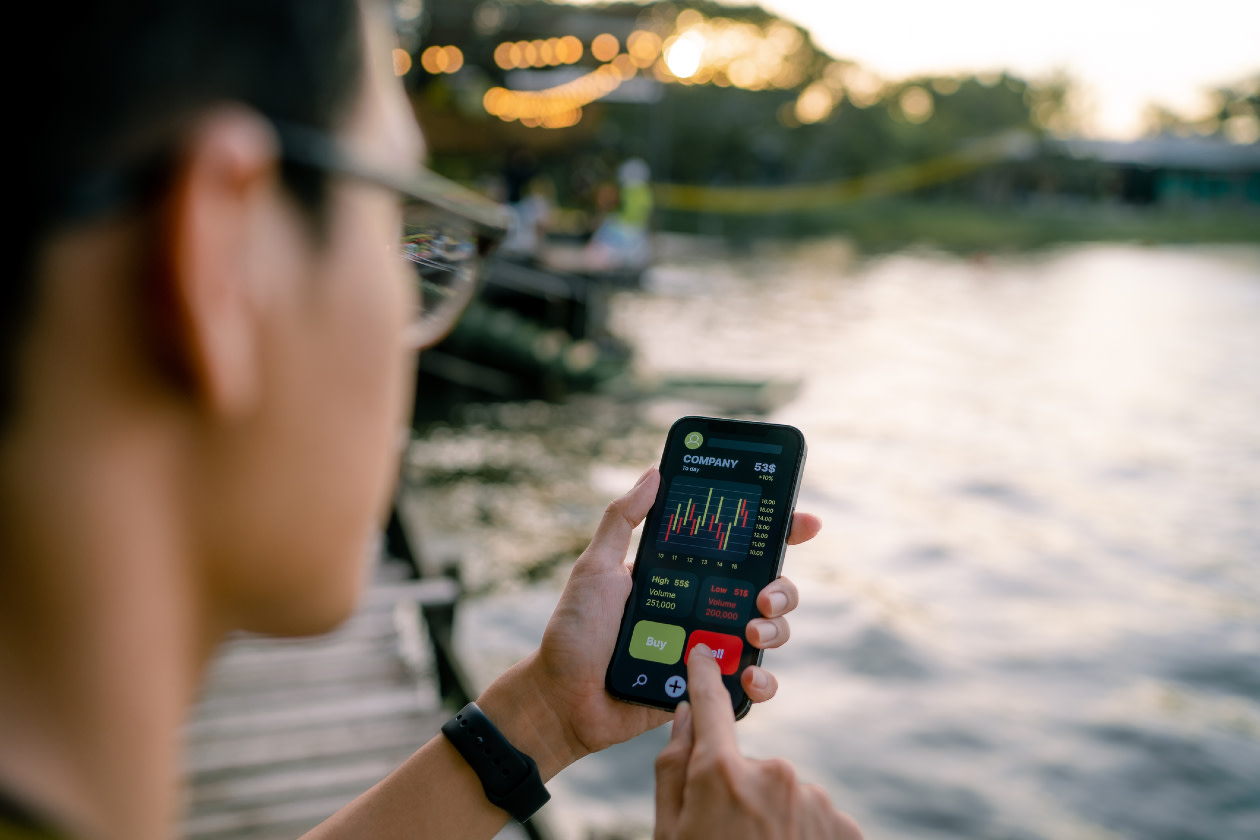 Young expert analyses financial charts on smartphone.jpg