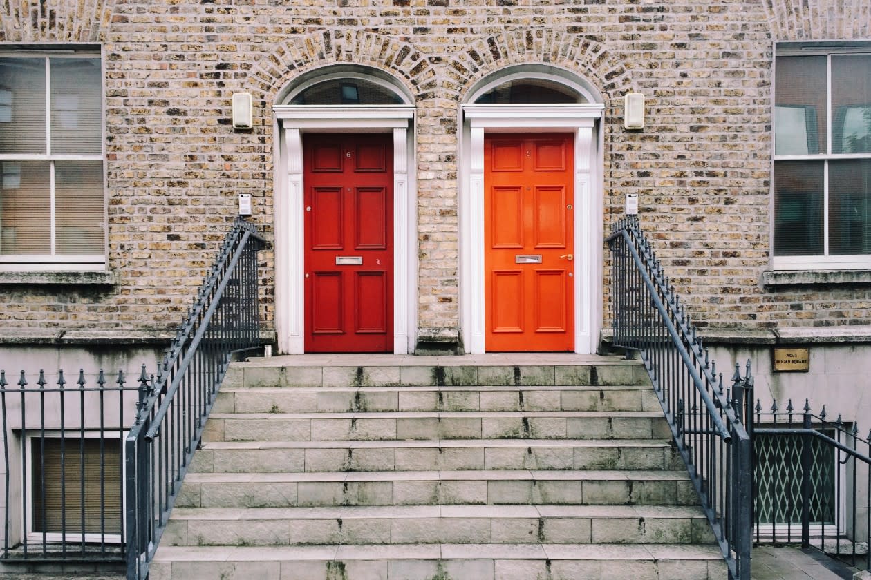 Steps leading up to two residential doors in orange and red.jpg