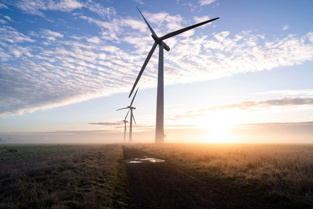 3 commercial wind turbines turning on a dewy British morning at dusk.jpg